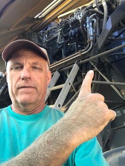 Ron Bokenfohr in front of his combine, during a repair session