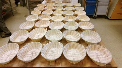 A bench full of empty baskets, waiting for their bread