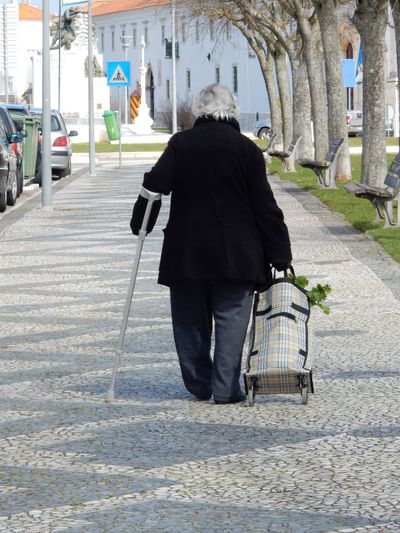 an elderly lady walking home with a basket of groceries, Estremoz Portugal, 2016